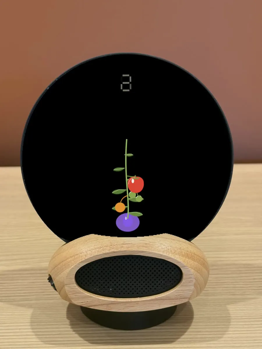 Morph on a desk: a tomato plant grows on the glass while the 25 minutes run; when it is ripe Morph asks whether to keep going instead of ringing