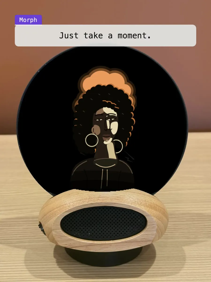 Morph on a desk: the character on the glass asks for one word for the day, waits while you find it, and keeps it for you